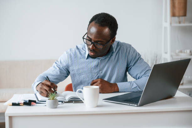 istock Doing some paperwork. Businessman is in the office by laptop 2032239763
