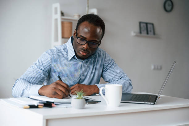 istock Doing some paperwork. Businessman is in the office by laptop 2032240839