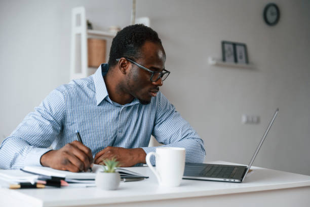 istock Doing some paperwork. Businessman is in the office by laptop 2032245684