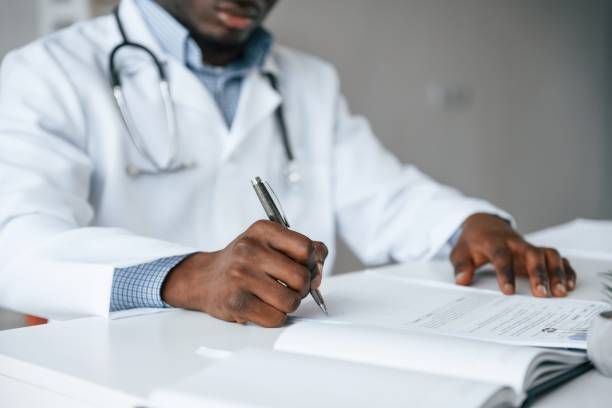 istock Black man as doctor in the clinic office 2032249470