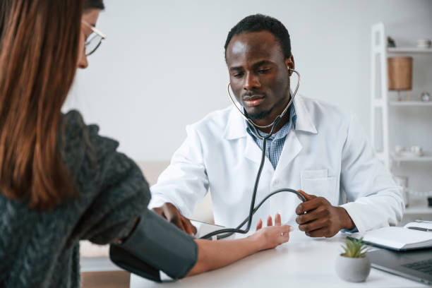 istock A doctor measures a young woman's blood pressure 2032249999