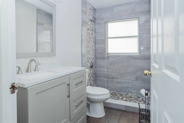 istock White and gray bathroom with a sink, mirror, and cabinets 2032254351