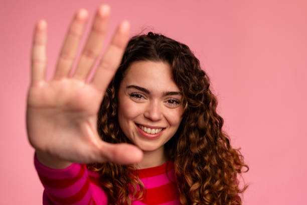 istock Friendly Woman Waving Hand Close-up 2032256528