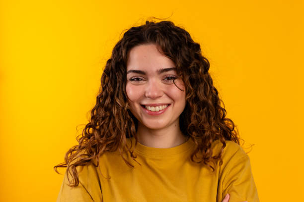 istock Happy Curly-haired Woman in Yellow 2032257617