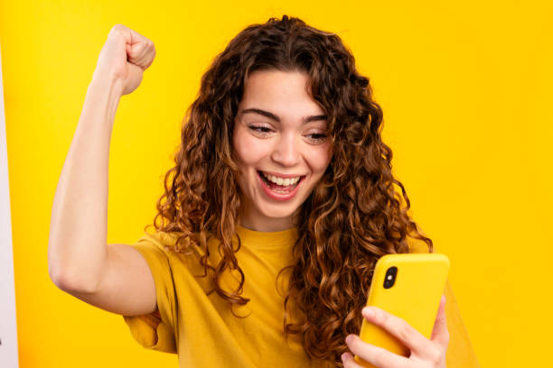 istock Young Woman with Excited Phone Reaction 2032258431