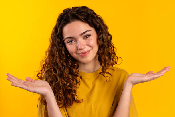 istock Young Woman Shrugging in Yellow 2032258663