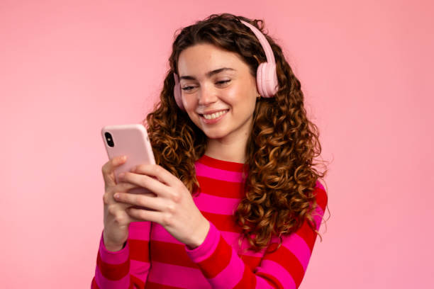 istock Smiling Woman Texting on Smartphone 2032259213