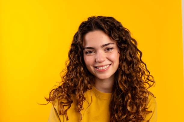 istock Smiling Young Female with Yellow Background 2032262398