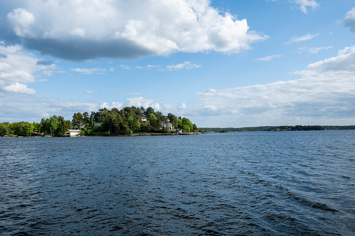 Stockholm Archipelago in all its glory from a boat on a clear spring day, enjoy scenic views of the vibrant islands, tranquil waters, and the Baltic Sea. Immerse yourself in the beauty of this Swedish maritime wonderland.