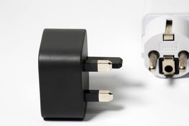 istock Black power plug UK type with European adapter on a white background 2032273249