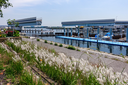 On a sunny day in May 2019, the stationary Haneda Movable Bridge on the Metropolitan Expressway stands at the seaside in Ota Ward, Tokyo.