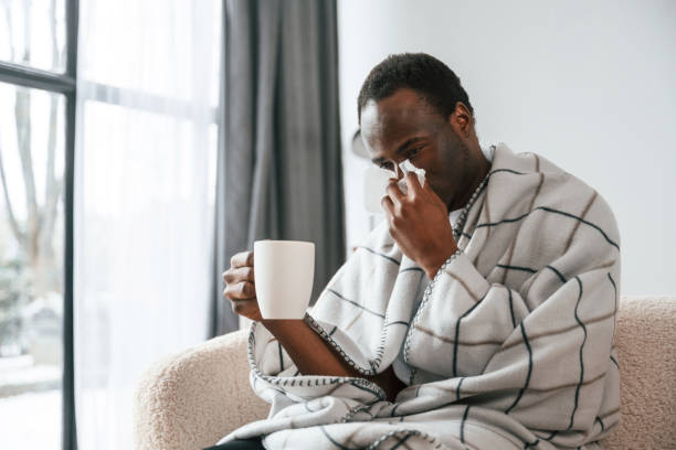 istock Terrible flu. Sick black man is at home 2032276051