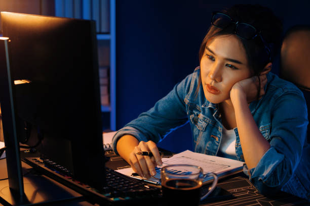 istock Exhausted young Asian creative feeling sleepy, looking on pc. Stratagem. 2032286866