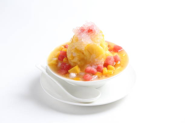 chilled mango and watermelon fruit snow ice kacang mountain in white bowl on white background asian cafe sweet dessert halal menu