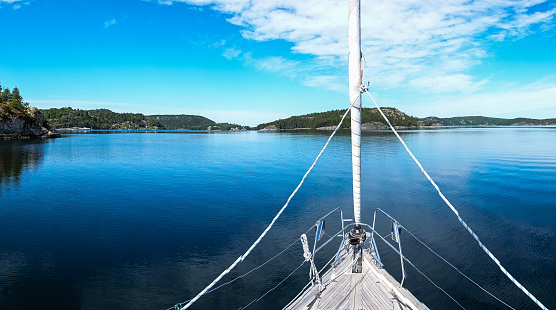 Gothenburg Archipelago in all its glory from a boat on a clear spring day, enjoy scenic views of the vibrant islands, tranquil waters, and the North Sea. Immerse yourself in the beauty of this Swedish maritime wonderland.