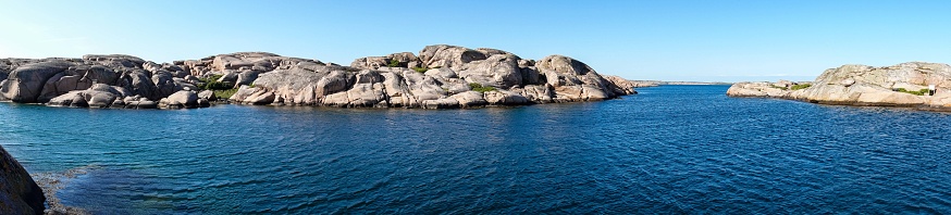 The scenic beauty of the small rocky islands off the coast of the Gothenburg Archipelago in Sweden. The rugged terrain, surrounded by the Nordic waters, showcases the idyllic coastal landscape, inviting travelers to explore the pristine and remote maritime retreat.