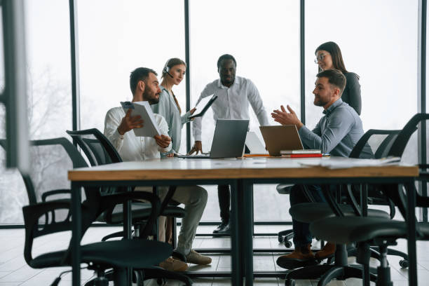 istock Against big panoramic windows. Team of office workers are together indoors 2032298762