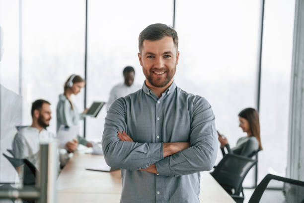 istock Handsome man with documents. Team of office workers are together indoors 2032298768