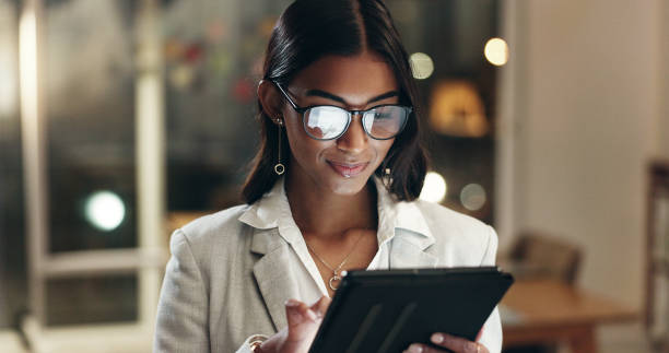 istock Tablet, reflection and woman in office with glasses, overtime with planning and scroll on social media. Vision, research and businesswoman typing email, late at night work on future ideas for agency. 2032300992
