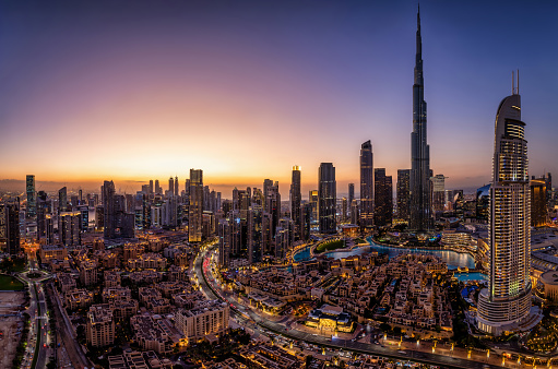 Panoramic view of the illuminated Downtown skyline of Dubai, UAE, during a clear dusk