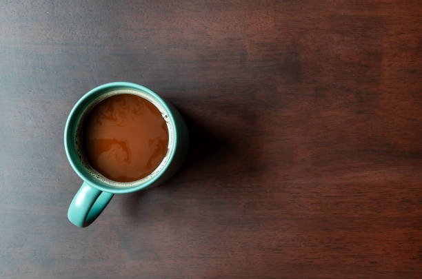 Ceramic mugs containing black coffee and herbal tea placed on white background