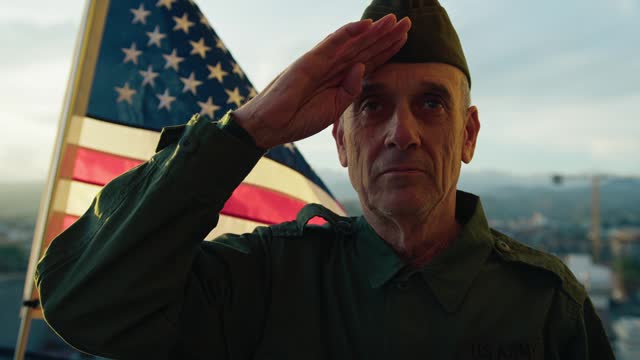 Senior Soldier Stand Against The American Flag For Veterans Day