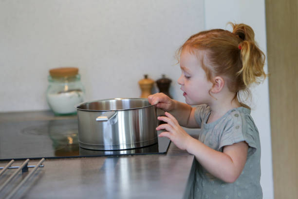 Little girl in a kitchen stock photo