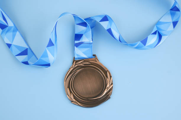 istock Bronze medal with ribbon on blue 2032327742