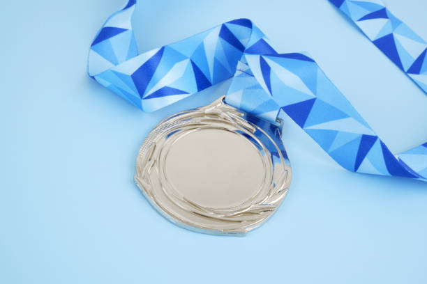 istock Silver medal with blue ribbon on blue 2032327758