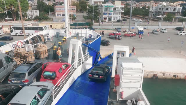 Car vehicles disembark from ferry boat on pier at Corfu, Greece, slow motion