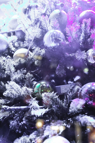 istock Christmas decorations close up, Christmas Tree Toppers, decorated trees with dazzling light displays, ornaments and defocused lights background 2032335953