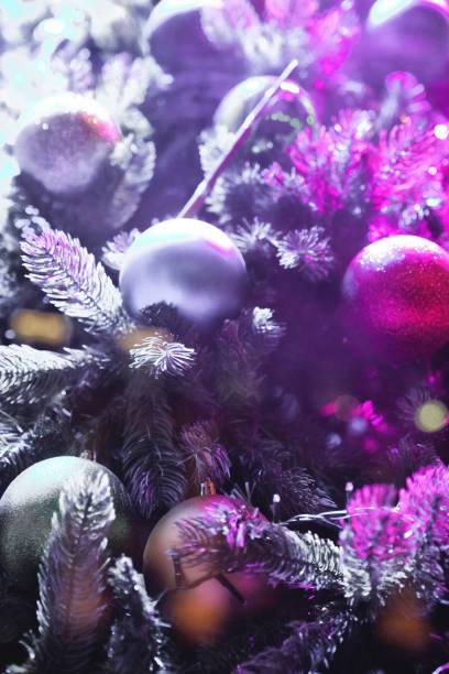 istock Christmas decorations close up, Christmas Tree Toppers, decorated trees with dazzling light displays, ornaments and defocused lights background 2032336471