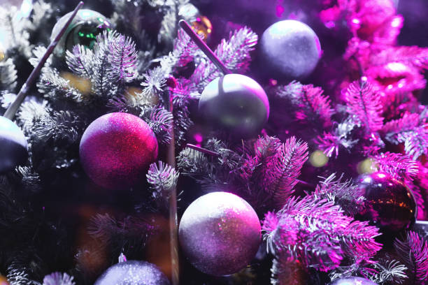 istock Christmas decorations, Christmas Tree Toppers, decorated trees with dazzling light displays, garland ornaments and defocused lights background, pine branches 2032336501