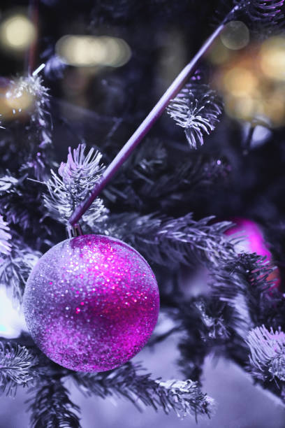 istock Christmas decorations, Christmas Tree Toppers, decorated trees with dazzling light displays, garland ornaments and defocused lights background, pine branches 2032336506