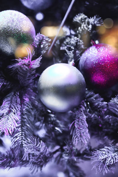 istock Christmas decorations close up, Christmas Tree Toppers, decorated trees with dazzling light displays, ornaments and defocused lights background 2032336514
