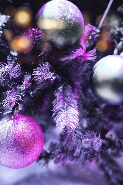 istock Christmas decorations close up, Christmas Tree Toppers, decorated trees with dazzling light displays, ornaments and defocused lights background 2032336525
