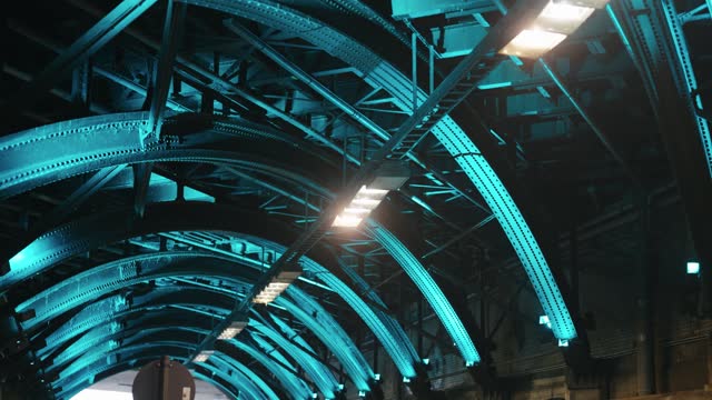Metal iron ceiling architecture of Trankgasse tunnel in Cologne illuminated with blue lights