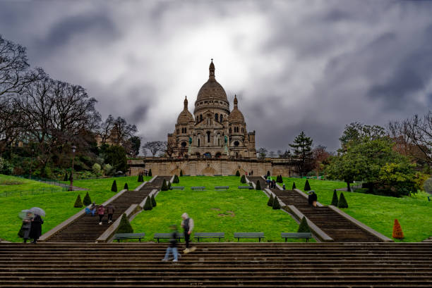 Long exposure of Sacre Coeur in the rain. There are a few people but due to long exposure they are no recognizable