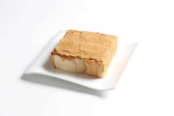 square peanut butter jam toast bread set with half boiled soft chicken egg and hot coffee or tea breakfast on white background asian chef appetiser halal bakery food restaurant pastry menu for cafe