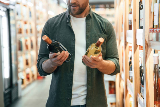 istock Man is choosing wine in the store 2032379535