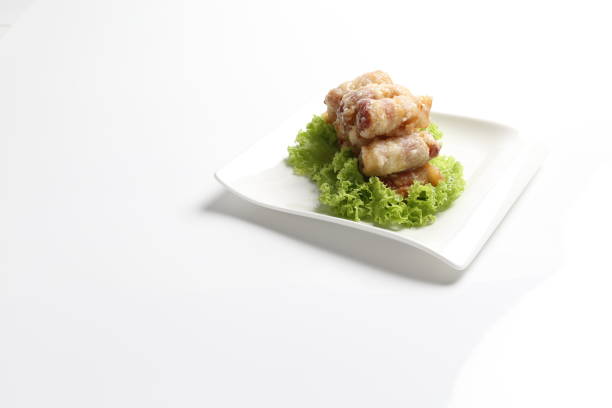 crispy deep fried bacon roll meat sausage with mayonnaise in plate on white background design dim sum appetiser food snack halal menu for Hong Kong cafe