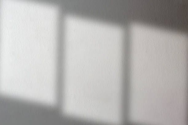 istock Realistic and natural blurred of window shadow and light over white wall. 2032391836
