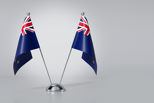 Double New Zealand Table Flag on Gray Background. 3d Rendering