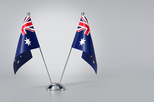 Double Commonwealth of Australia Table Flag on Gray Background. 3d Rendering
