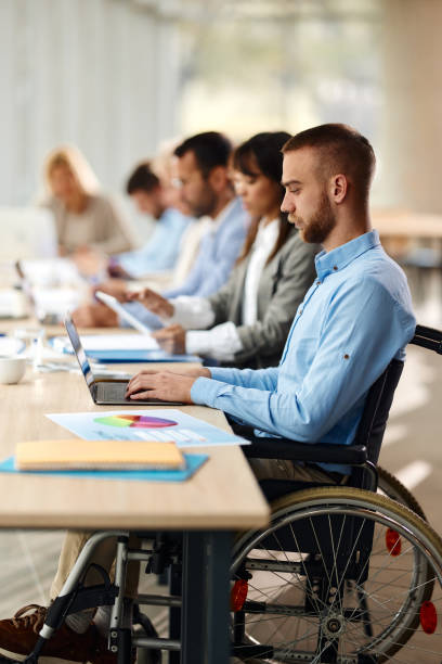 istock Disabled businessman using laptop on a meeting in the office. 2032400369