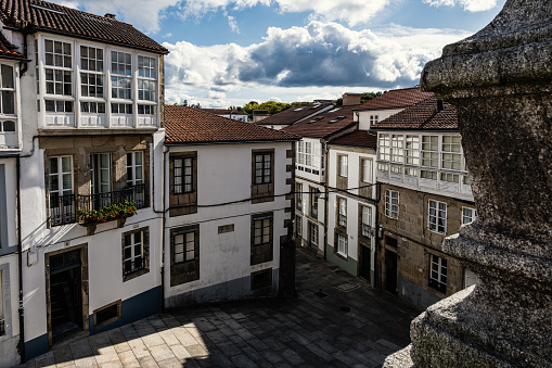 An elevated shot of Avenida de Raxoi, a narrow pedestrian street a stone's throw from the Pazo de Raxoi (Raxoi Palace, seat of the city council) and the Cathedral of Santiago de Compostela. Buildings displaying typical Galician architecture.