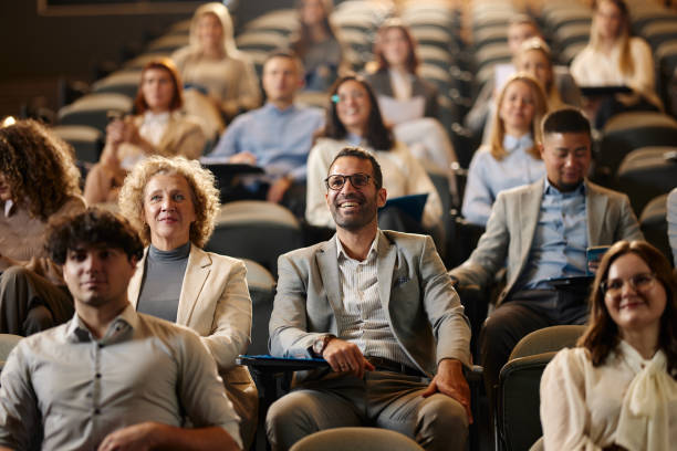 istock Happy entrepreneurs attending a seminar in convention center. 2032405222