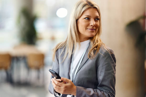 istock Pensive businesswoman using mobile phone in the office. 2032407947