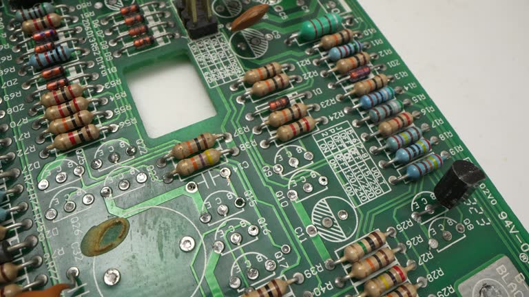 Electronic components inside a technological device: microchips, transistors, LEDs, and semiconductors. Technological background of electronic circuit board.