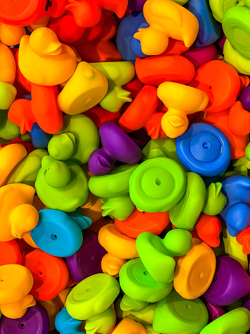 Many yellow color classic and generic rubber ducks are scattered to form a background or surface.